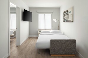 Premium bedding, desk, laptop workspace, blackout drapes