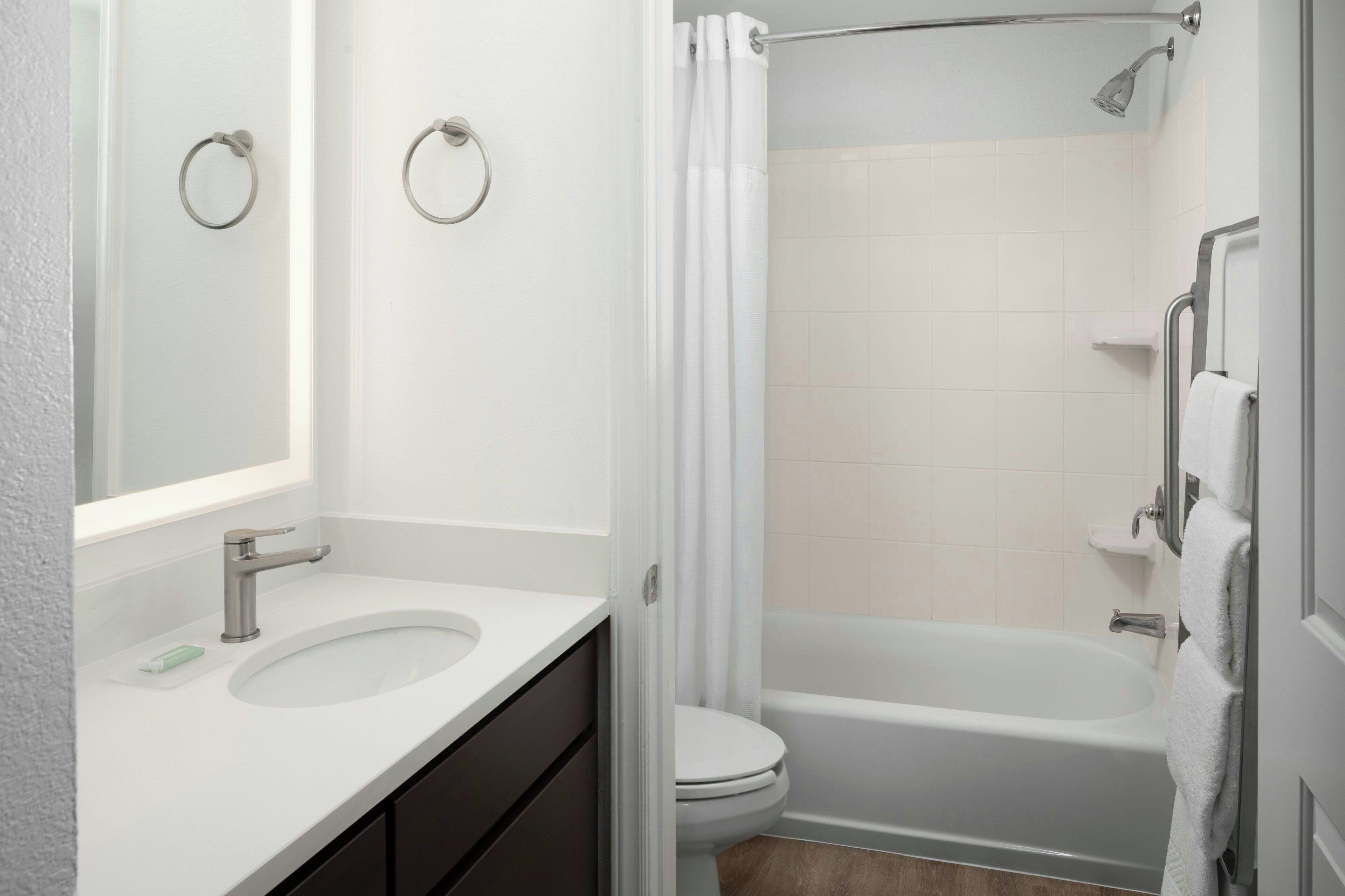 A bathroom with a sink, toilet, and bathtub.