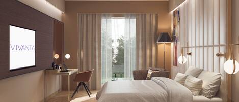 A modern bedroom with a large bed, a desk, and a TV displaying "VIVANTA".