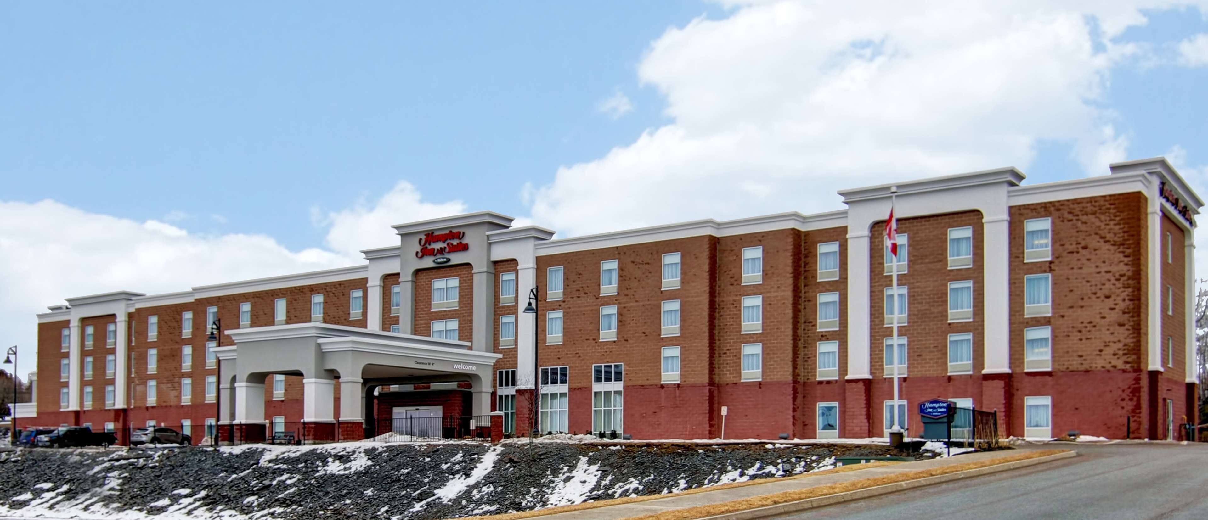A large brick hotel with a central entrance and multiple windows.