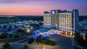 A hotel with a large parking lot, a well-lit entrance, and a prominent hotel sign. - Isle Casino Hotel Waterloo - A Caesars Rewards Destination (Waterloo)