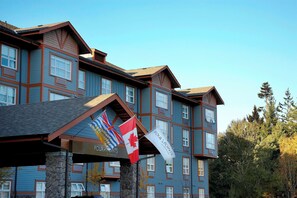 A multi-story building with a stone facade and a series of windows.