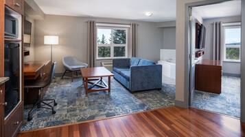 Executive Suite, 1 Bedroom | Living room | 55-inch LED TV with cable channels, TV, pay films