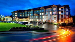 A multi-story hotel with a parking lot and a well-lit driveway. - Four Points by Sheraton Victoria Gateway (Victoria)