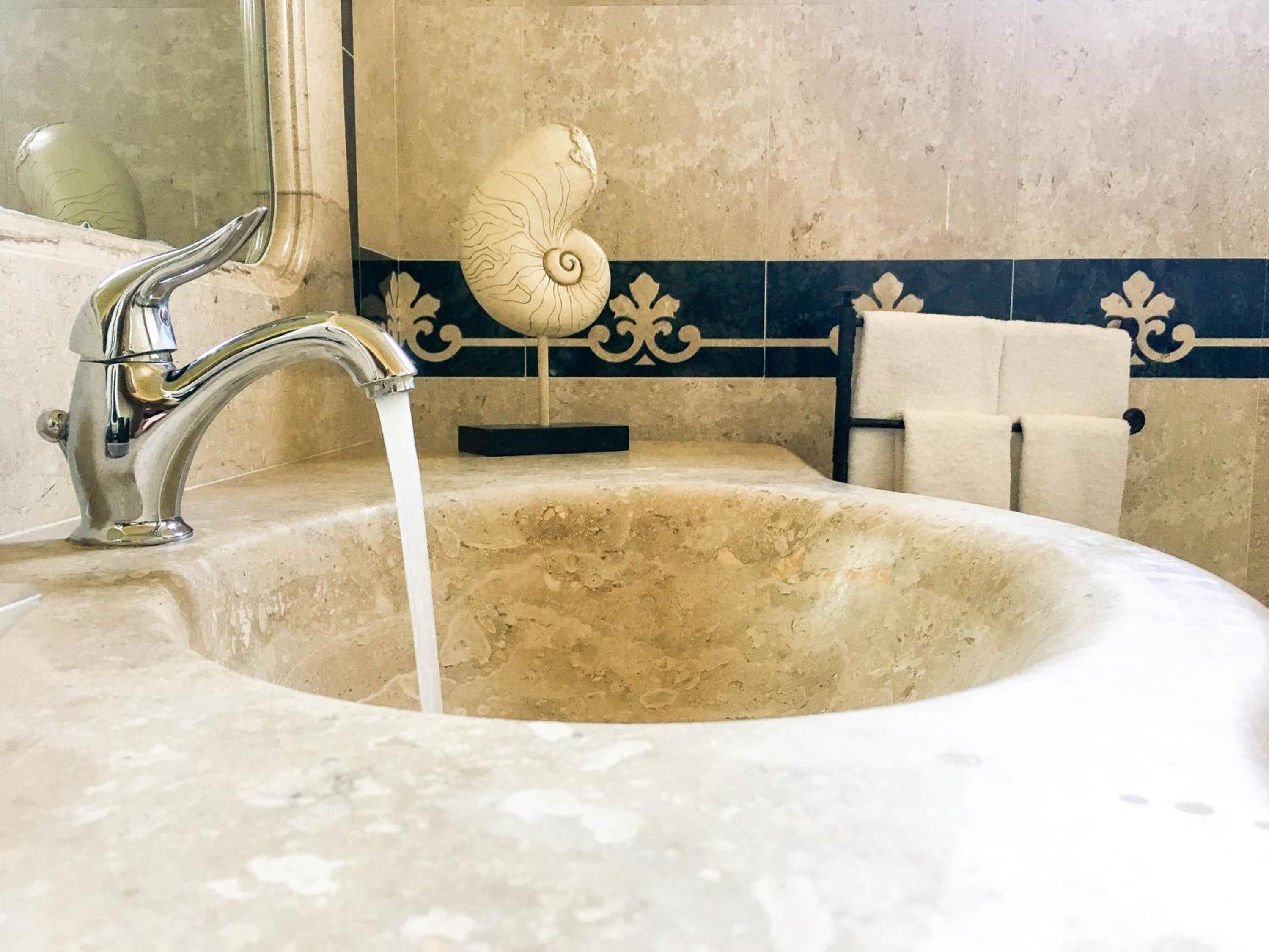 designer toiletries, hair dryer, towels