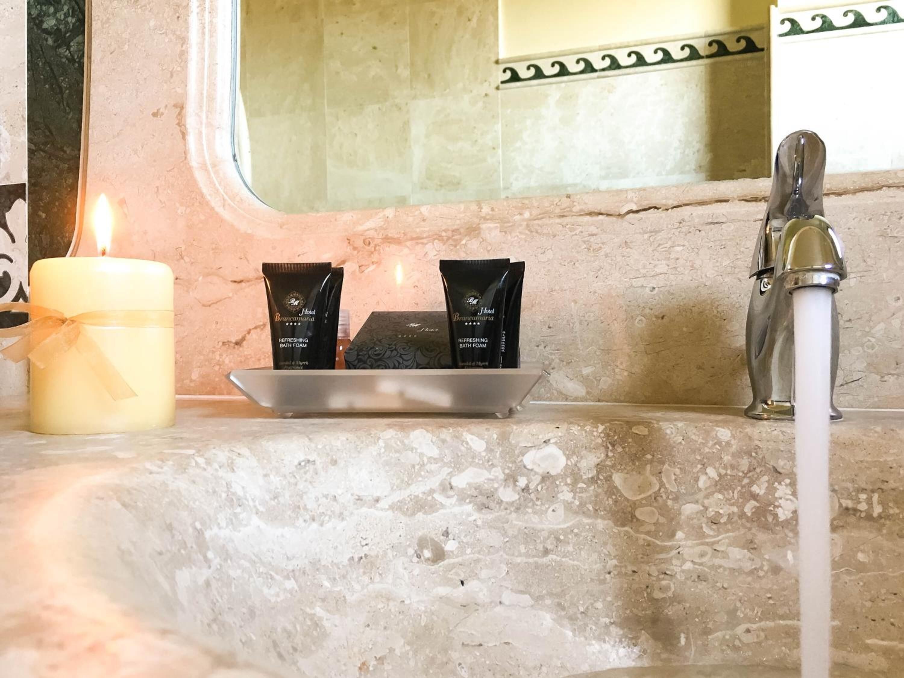 designer toiletries, hair dryer, towels