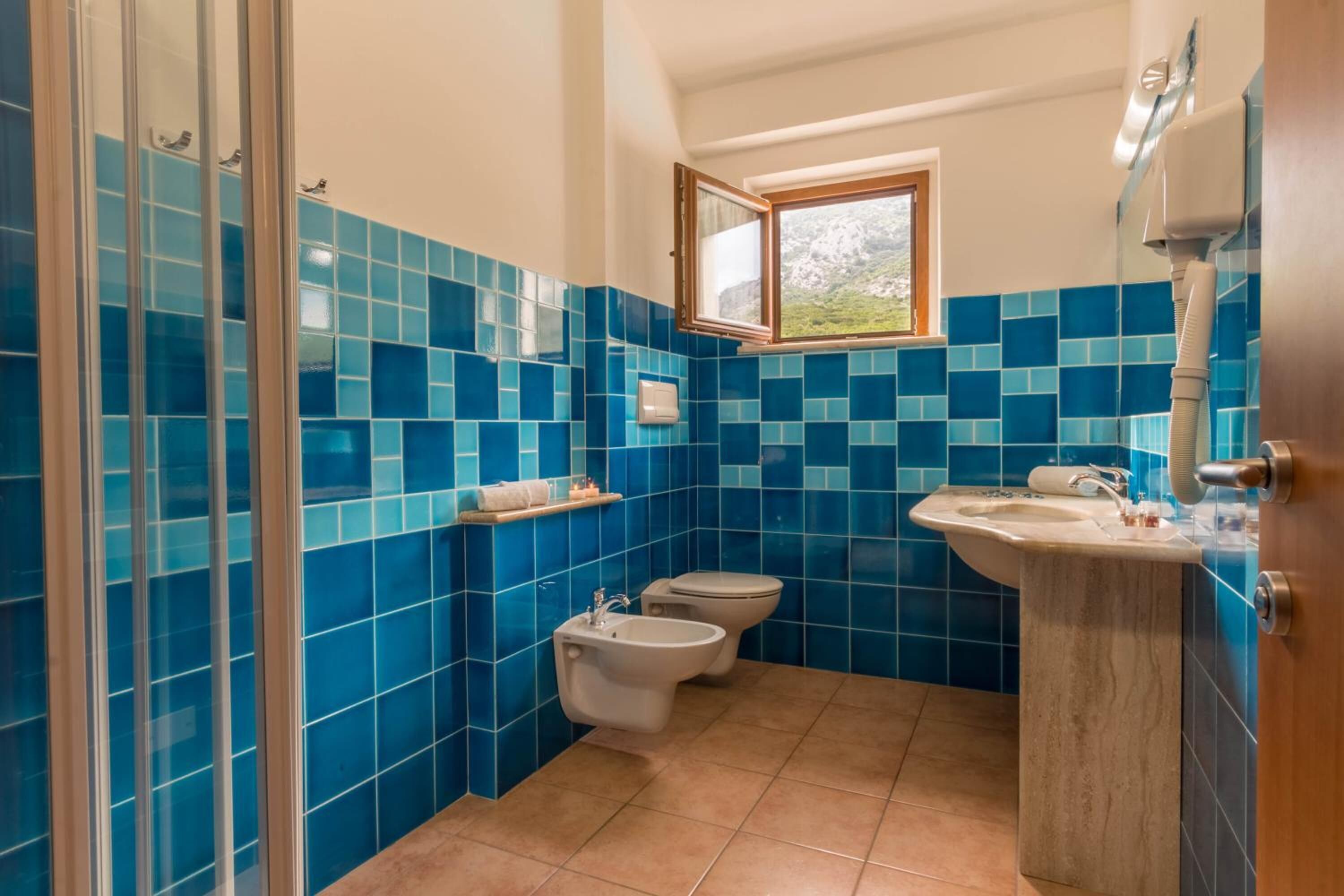 designer toiletries, hair dryer, towels