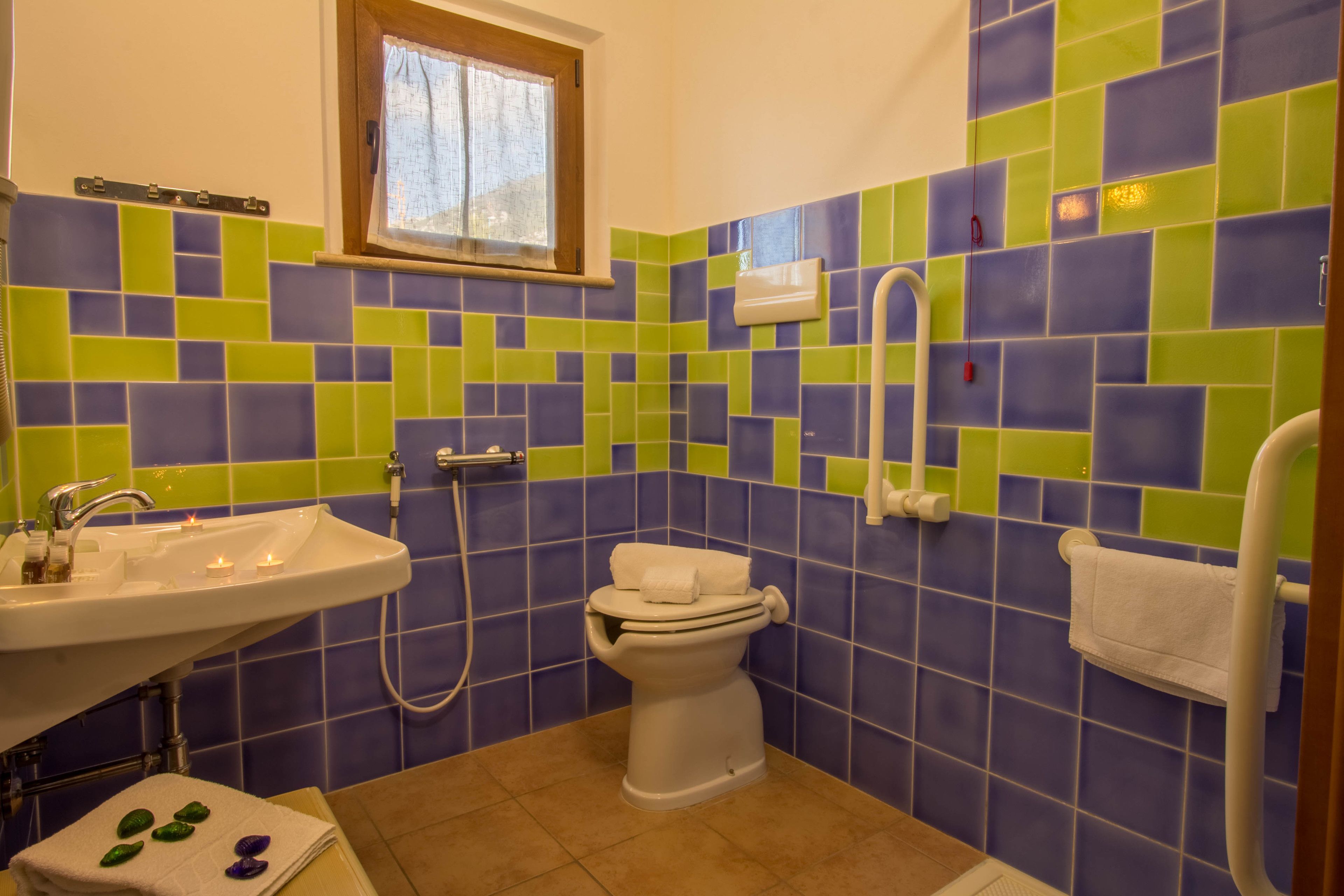A bathroom with a sink, toilet, and shower.