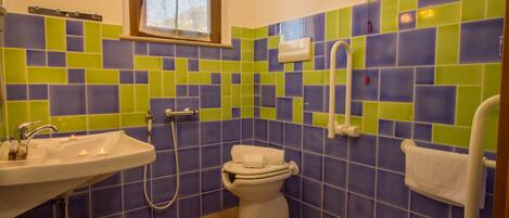 A bathroom with a sink, toilet, and shower.