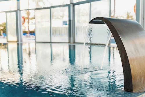 Indoor pool, seasonal outdoor pool, pool umbrellas, pool loungers