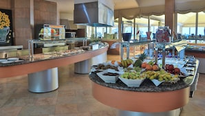 A buffet area with various food items and a large window in the background. - Senator Águilas Hotel (Aguilas)