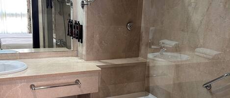 A modern bathroom with a bathtub, a sink, a mirror, and a towel rack.