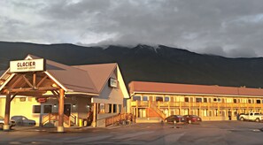 Glacier Basecamp Lodge with a covered entrance, a lobby, and a parking area.