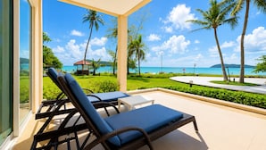 A balcony with two lounge chairs, a small table, and a view of the ocean with palm trees and a gazebo. - The Frangipani Langkawi Resort & Spa (Langkawi)