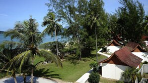 A coastal area with white buildings, palm trees, and a view of the sea. - The Frangipani Langkawi Resort & Spa (Langkawi)