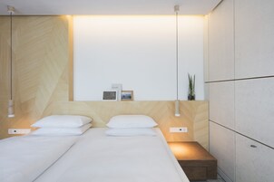 Hypo-allergenic bedding, desk, laptop workspace, blackout drapes
