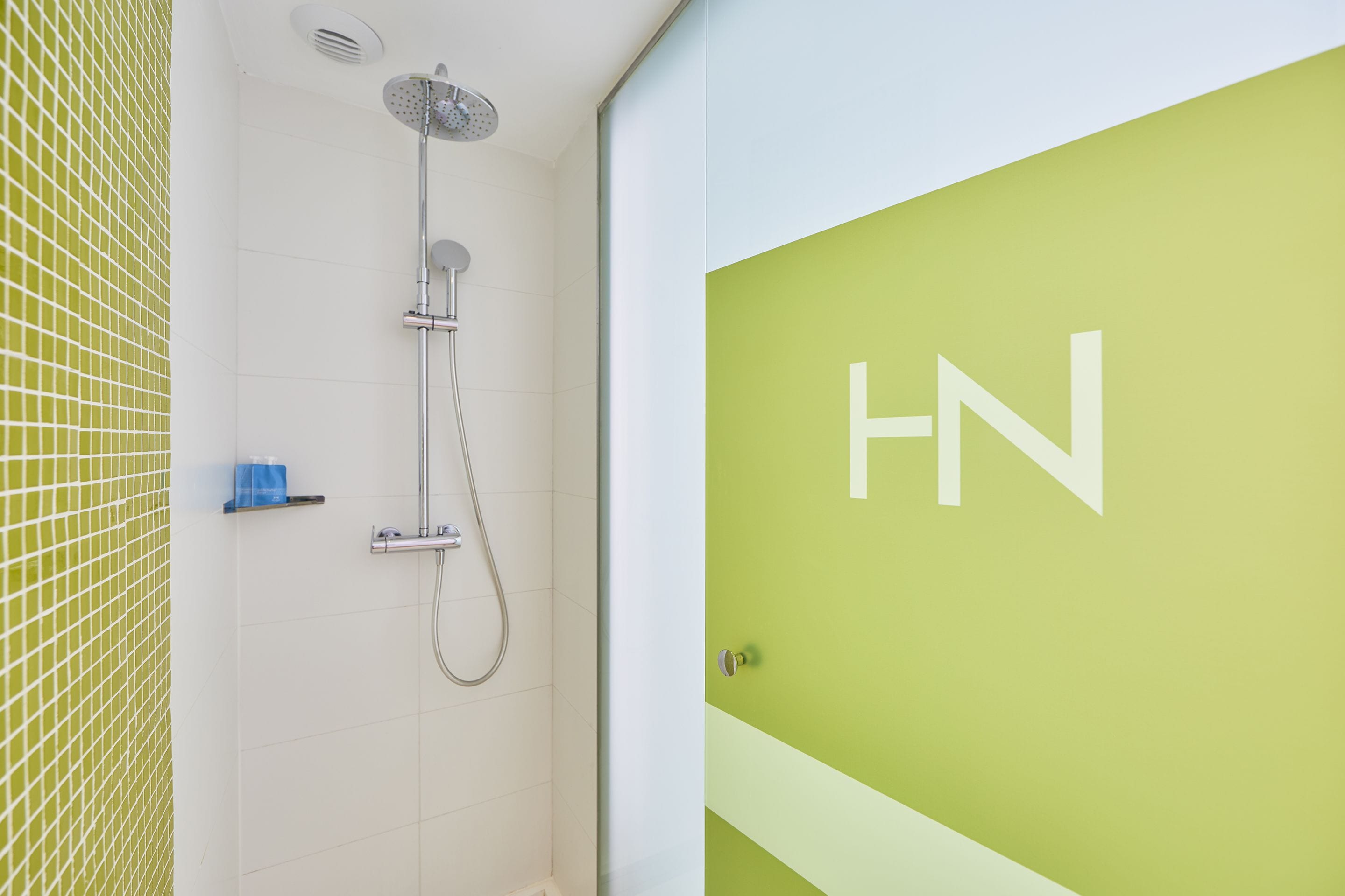 A bathroom with a shower, a toilet, and a sink.