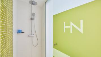 A bathroom with a shower, a toilet, and a sink.
