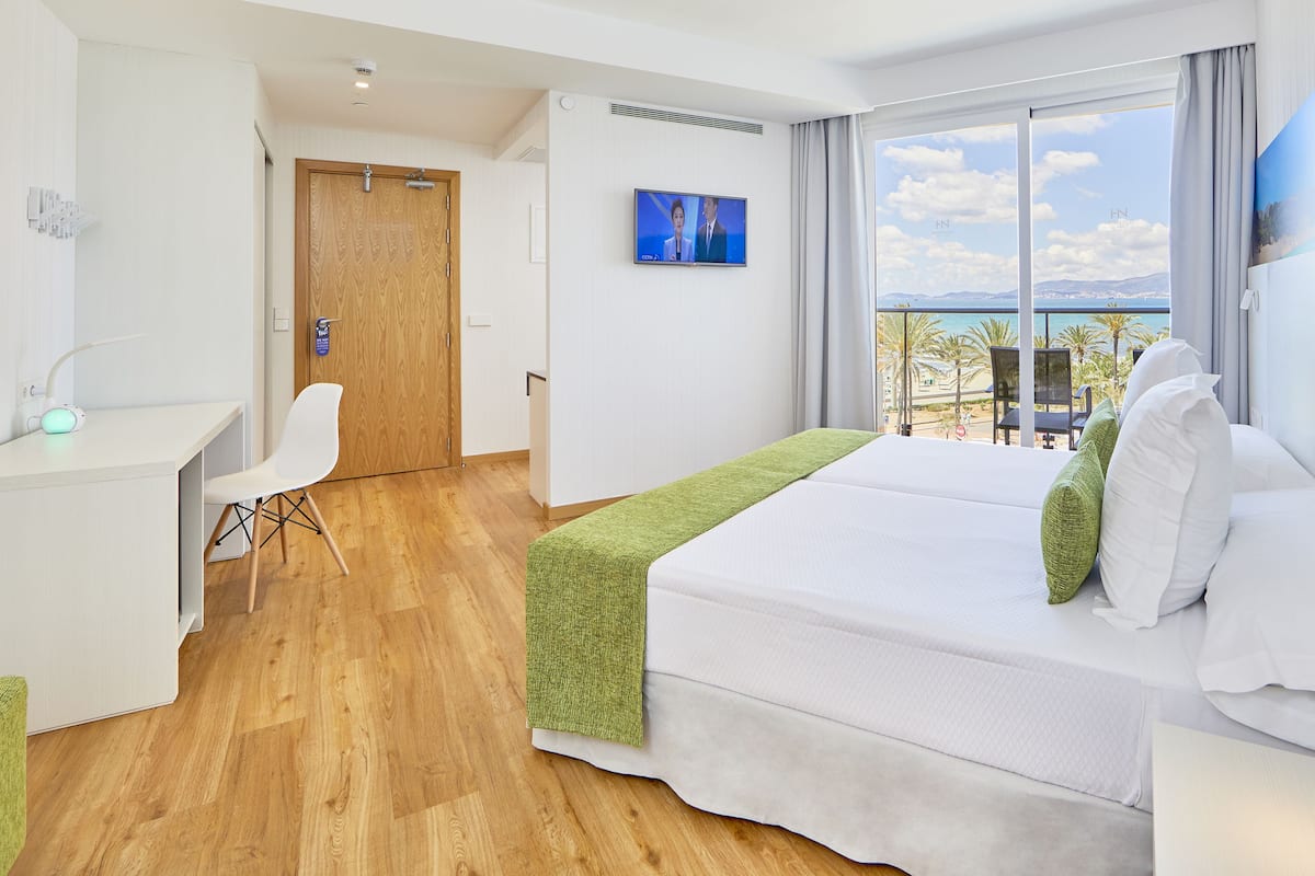 Superior Double Room, Partial Sea View | Minibar, in-room safe, desk, blackout drapes