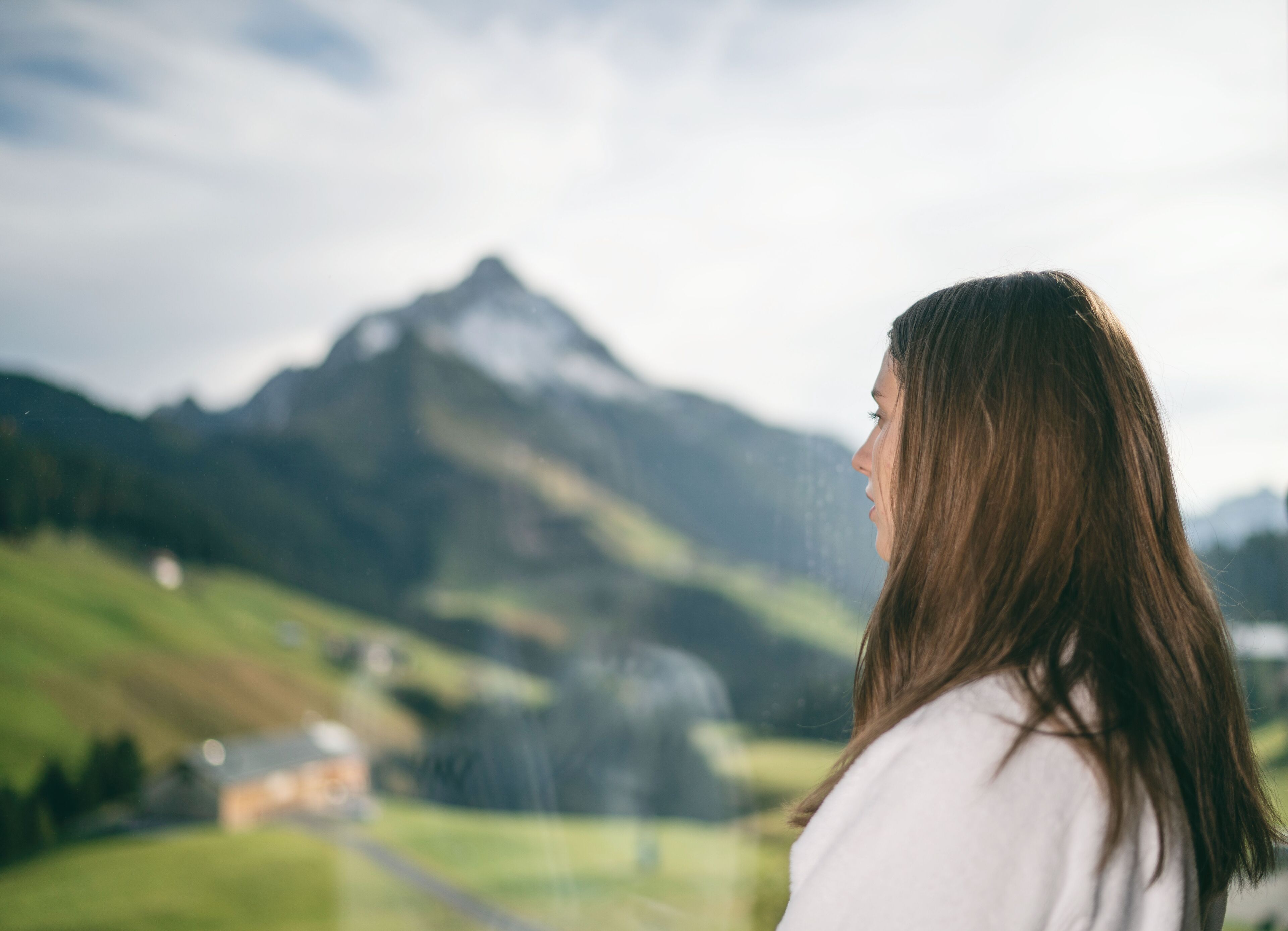 A person overlooking a mountainous landscape with a clear sky.