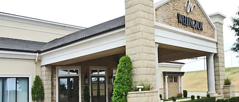 A hotel entrance with a prominent sign reading "Wellington."