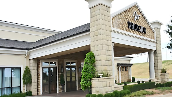 A hotel entrance with a prominent sign reading "Wellington."