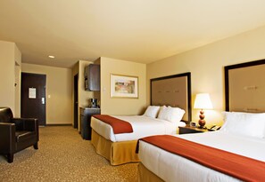 A hotel room with two beds, a desk, a chair, a lamp, and a painting on the wall. - Holiday Inn Express & Suites Wichita Falls by IHG (Wichita Falls)