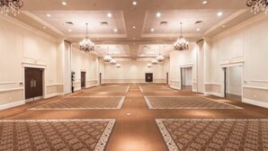 A large, well-lit conference room with a high ceiling, chandeliers, and patterned carpet. - Holiday Inn Express & Suites Wichita Falls by IHG (Wichita Falls)