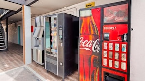 A vending machine with a Coca-Cola logo and a Coca-Cola themed mural on the wall. - Downtown Phoenix Hotel (Phoenix)