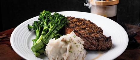 A plate with a steak, broccoli, and mashed potatoes.