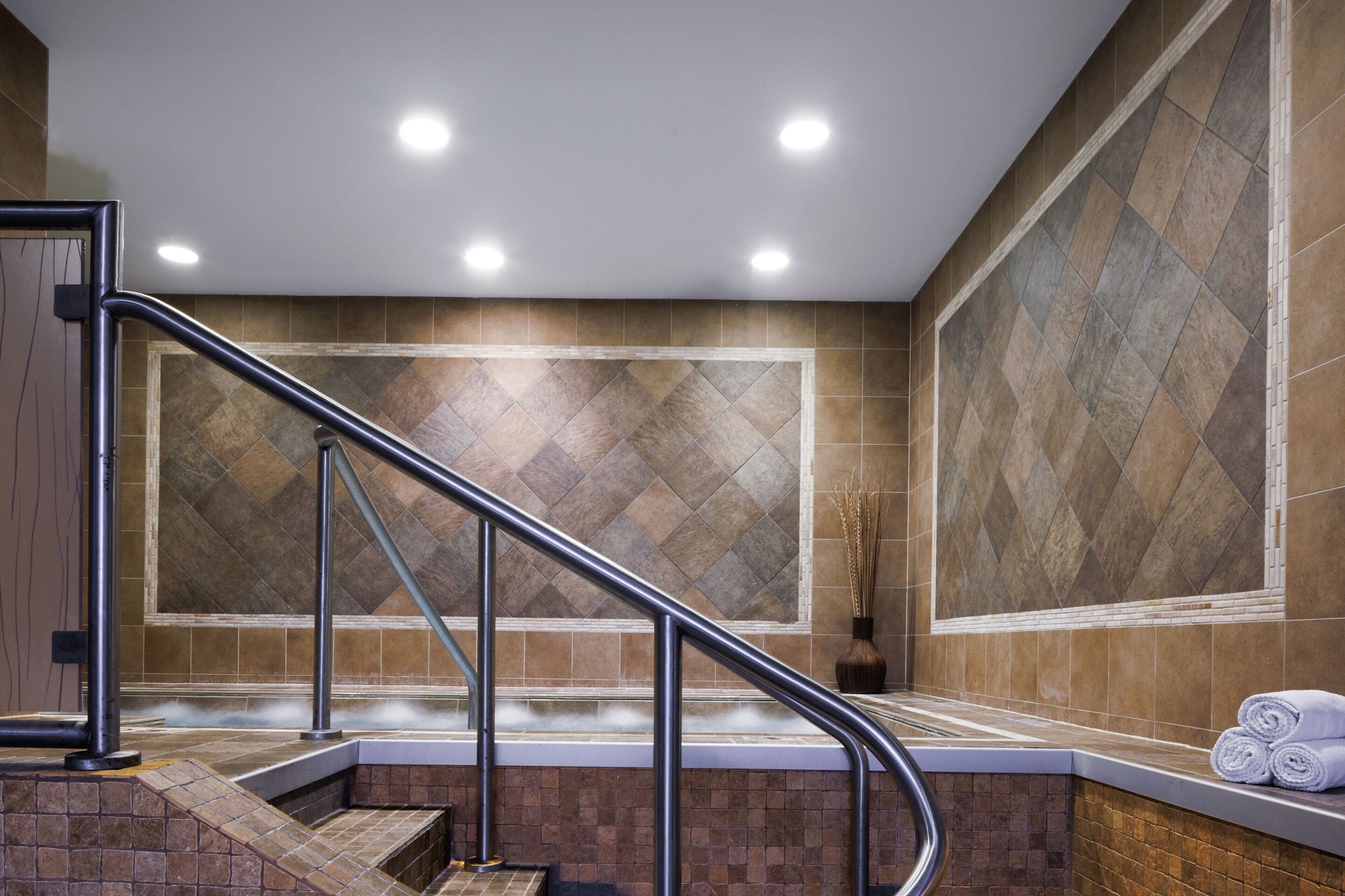 A modern bathroom with a shower, a bathtub, and a toilet.