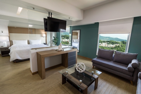 Suite, 1 King Bed | Living area | 32-inch LCD TV with satellite channels, TV