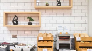 A bakery display with bread and pastries, a coffee machine, and a sign about allergies and intolerances. - Holiday Inn Express Hull City Centre by IHG (Hull)