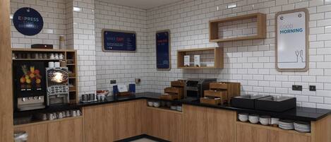 A modern kitchen area with a coffee station, a wake-up sign, and a breakfast sign.