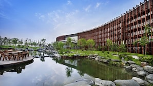 A modern building with a reflective water feature in front. - Jin Jiang International Hotel Xi'an (Xi'an)