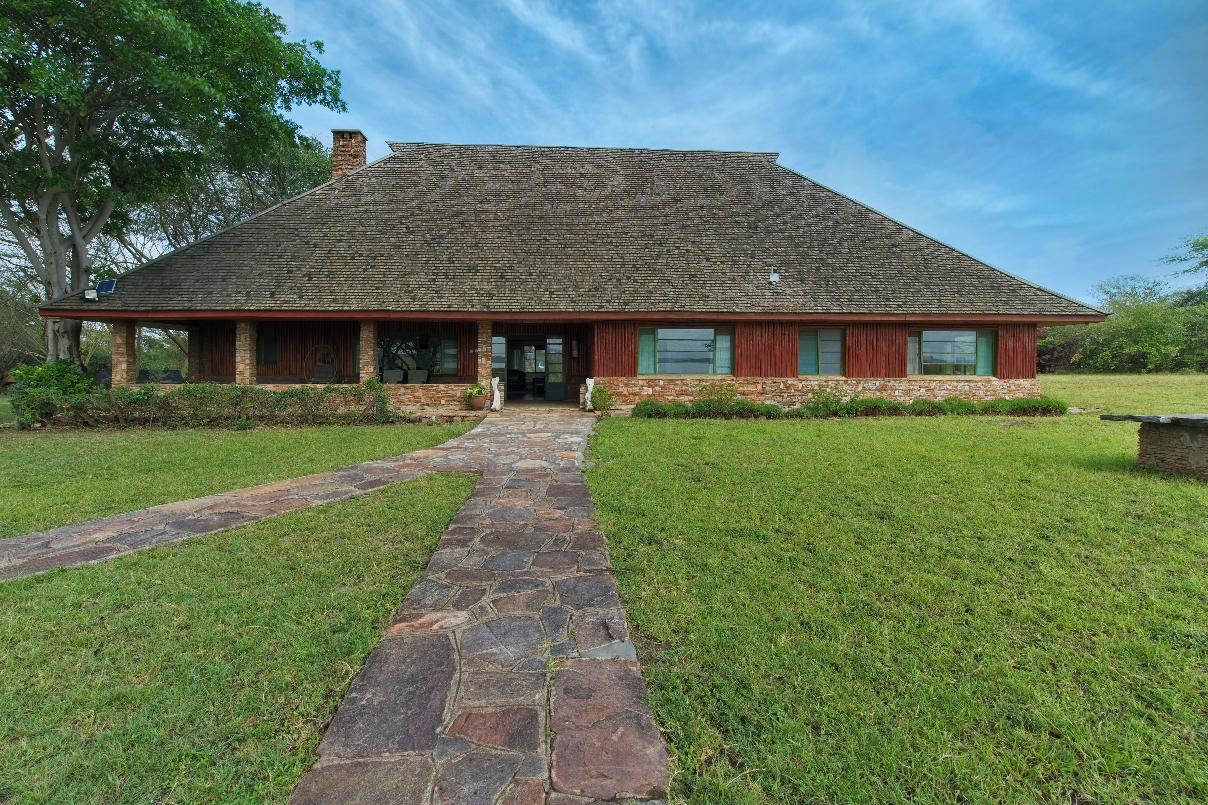 A rustic building with a stone pathway leading to the entrance.