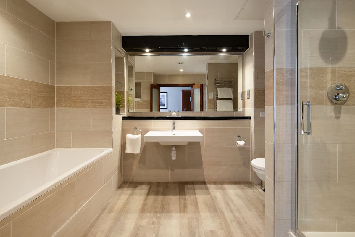 junior suite | bathroom | separate bathtub and shower, free toiletries, hair dryer, towels