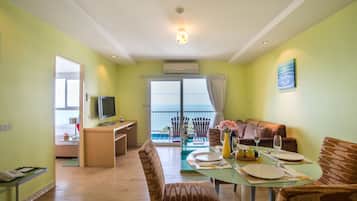 Family Suite, 2 Bedrooms | Living area | 32-inch LCD TV with cable channels, TV, fireplace