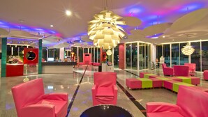 A modern lobby with bright pink seating, large windows, and unique ceiling lighting. - Best Bella Pattaya (Pattaya)