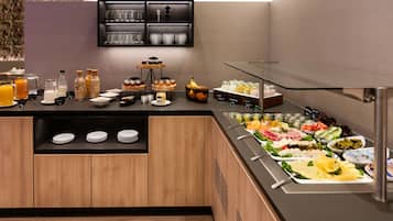 A buffet setup with various food items and beverages.