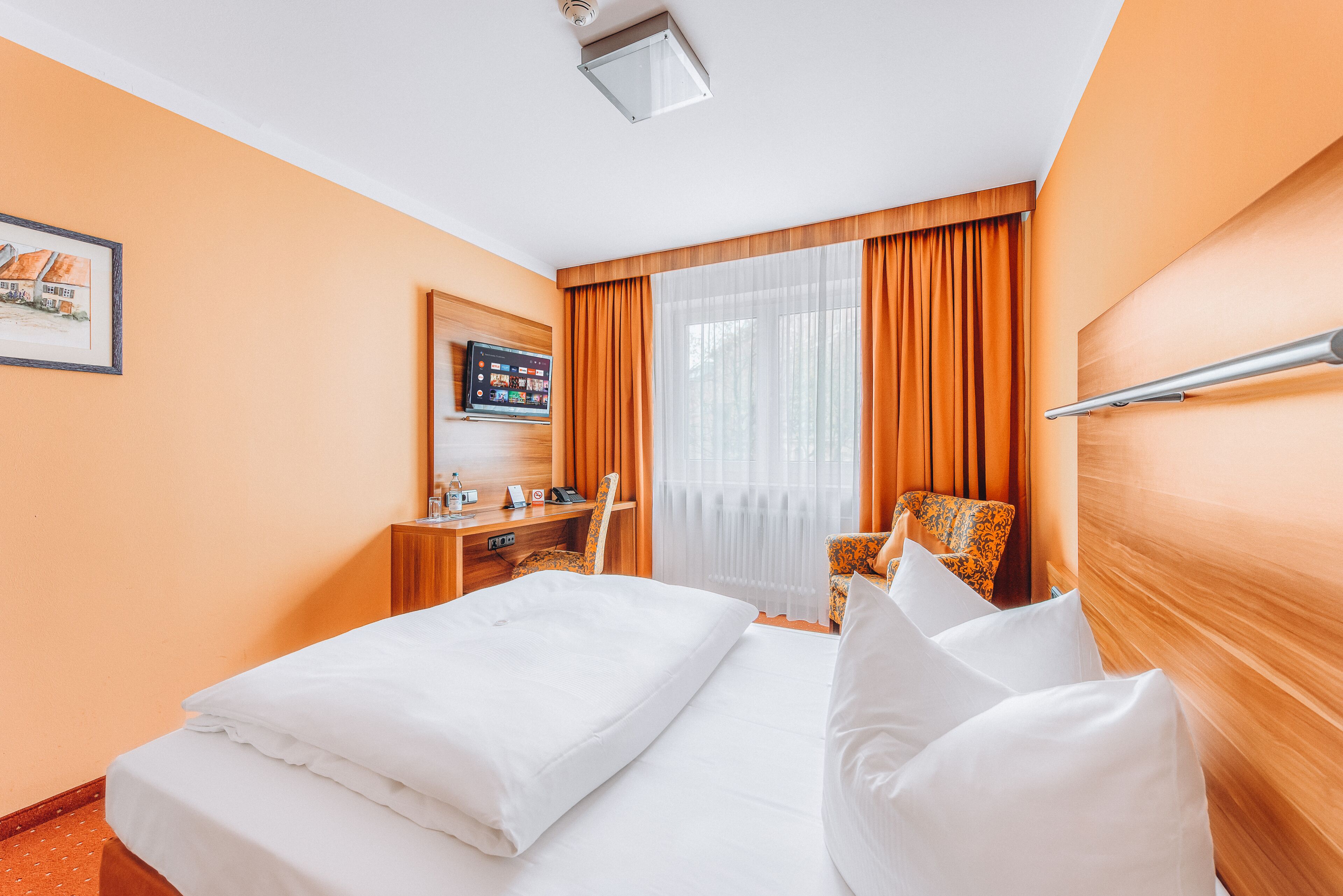 comfort single room | hypo-allergenic bedding, down duvets, in-room safe, desk