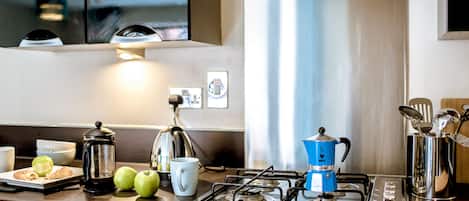 Fridge, microwave, coffee/tea maker, cookware/dishes/utensils