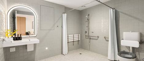 A modern bathroom with a shower, toilet, and sink.