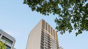 A high-rise building with multiple balconies and a modern architectural design.