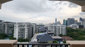 A high-rise residential building with multiple balconies, a view of a city skyline, and a mix of modern and traditional architecture. - Holiday Place (Kuala Lumpur)