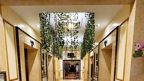 A hotel lobby with a marble floor, a reception desk, and a sign reading "HOLIDAY PLACE". - Holiday Place (Kuala Lumpur)