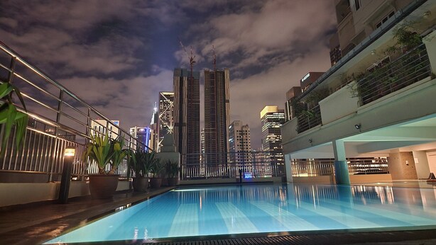 A rooftop pool with a city skyline in the background. - Holiday Place (Kuala Lumpur)