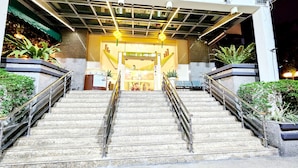 A hotel entrance with a staircase leading up to a reception area. - Holiday Place (Kuala Lumpur)