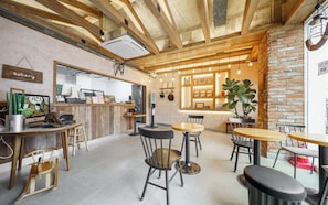 A cozy cafe with wooden furniture, a bakery sign, and a brick wall. - Incheon Airport Hotel Oceanside (Incheon)