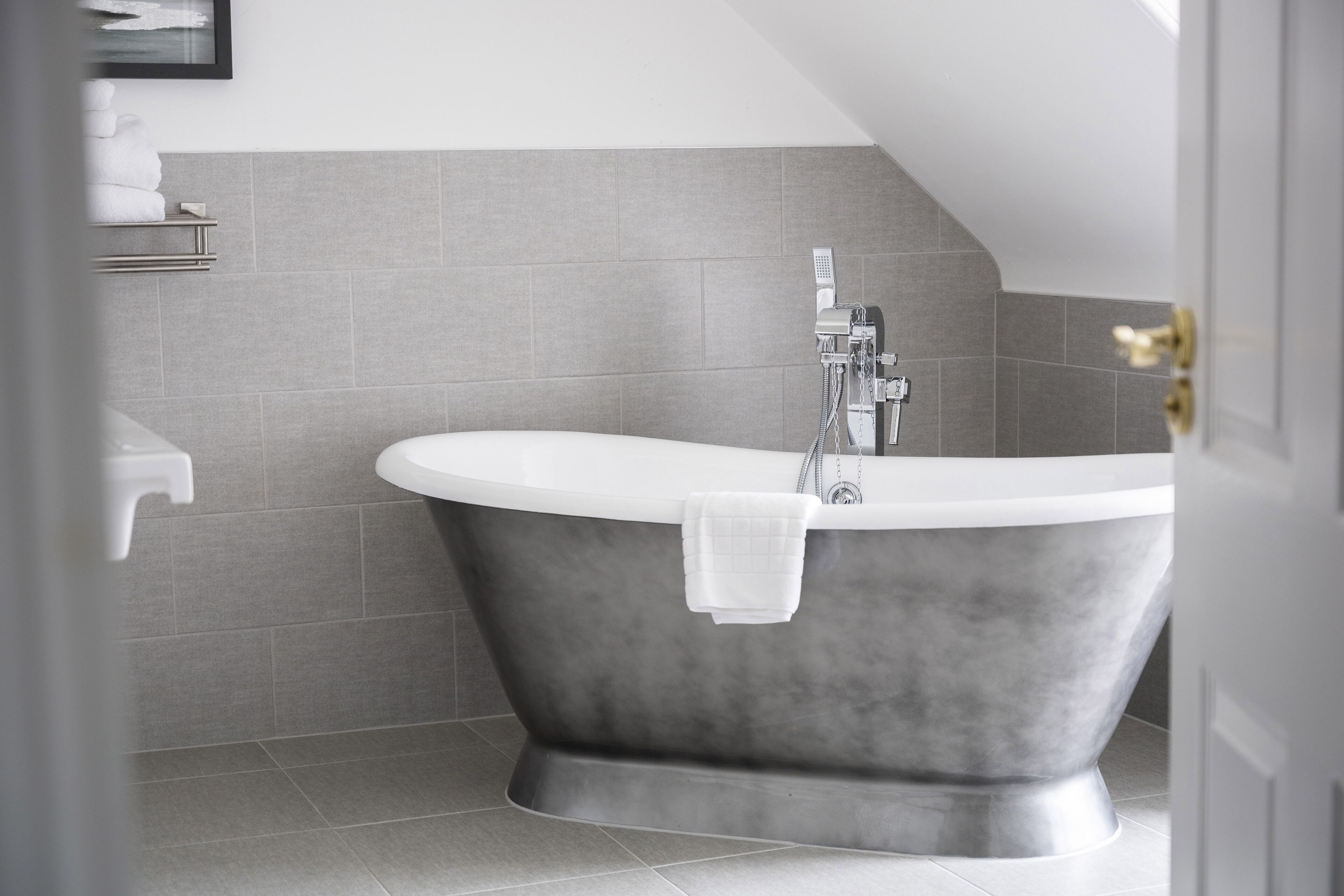 A modern bathroom with a freestanding bathtub, a toilet, and a sink.